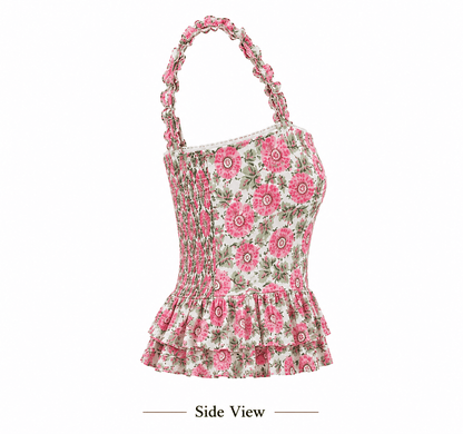 A floral halter top shown from the side on a white background, featuring pink and green flowers on a cream base with a smocked bodice and ruffled hem.